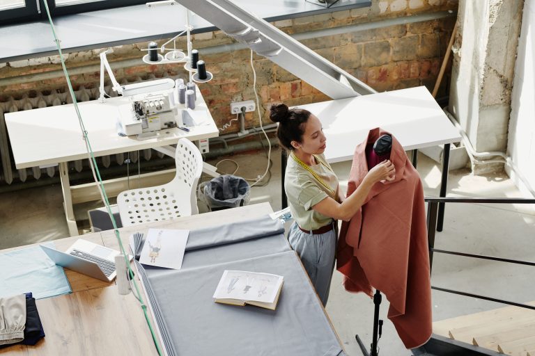 Garment workers at sewing stations in a textile workshop