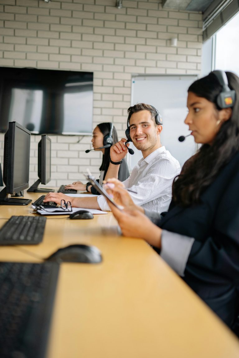 Office employees working at computers and reviewing information