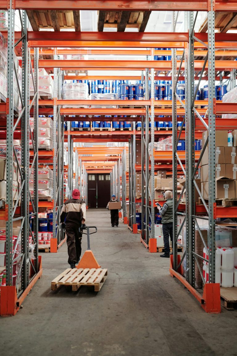 Warehouse worker picking an order between storage racks